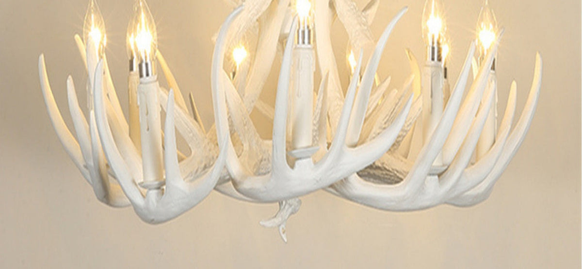 White antler chandelier with multiple lights on a neutral background