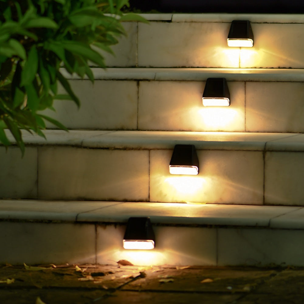Solar lights on outdoor steps with a warm glow