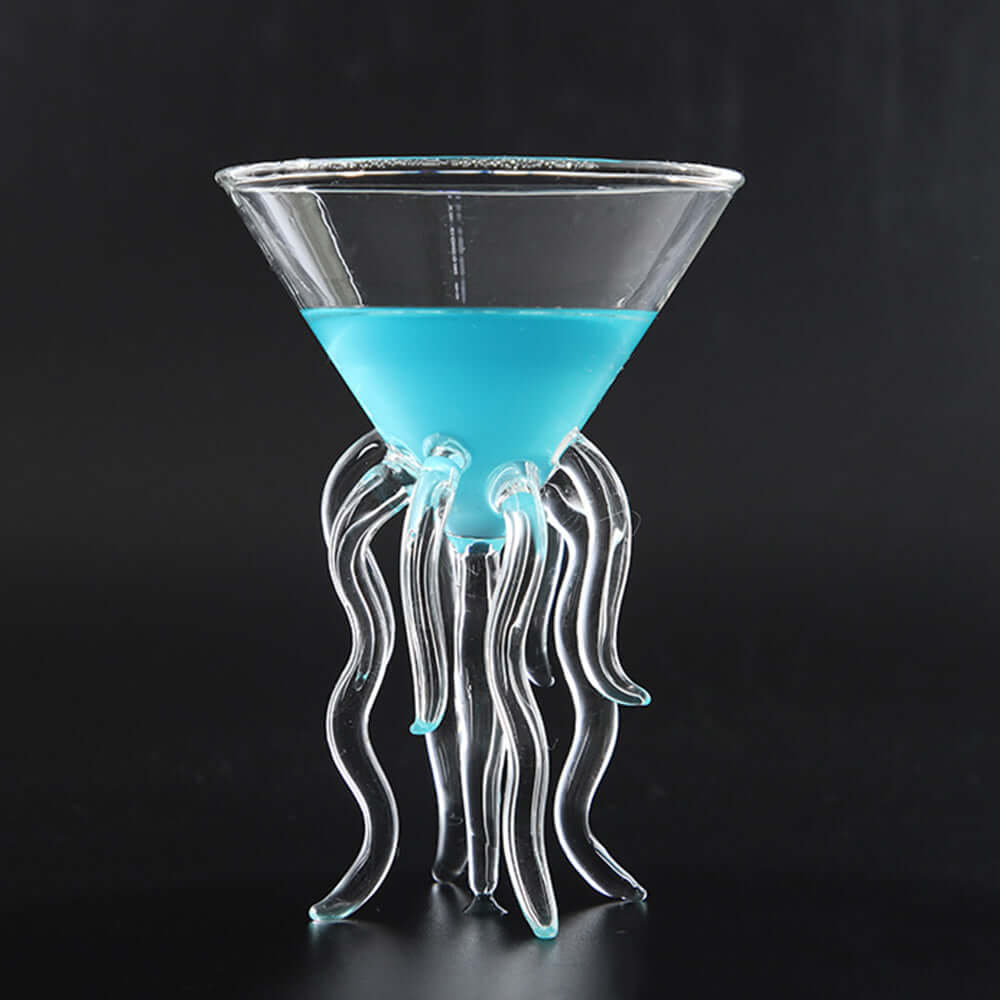Octopus Cocktail Glass Transparent Jellyfish Glass Cup Juice Glass Goblet Conical Wine Champagne Glass filled with blue drink.