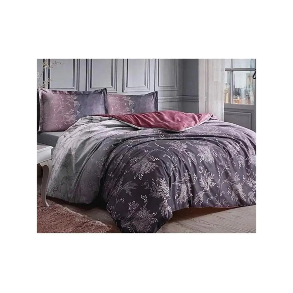 Bed with purple floral bedding in a bedroom setting