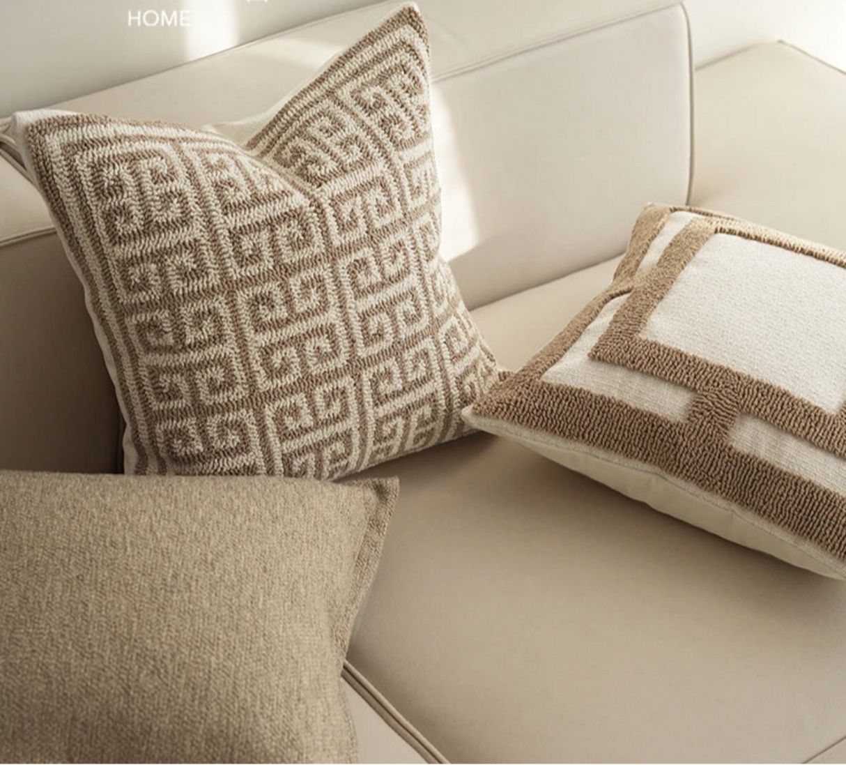 Decorative pillows with geometric patterns on a beige sofa, featuring the Backo Home brand.
