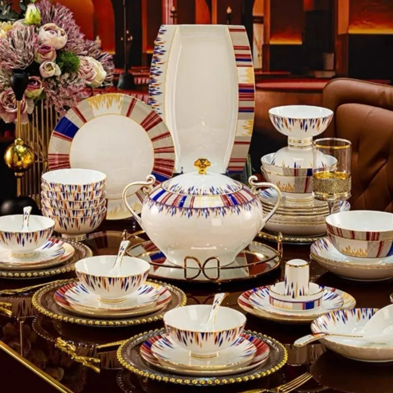 Decorative ceramic tableware set with colorful patterns on a reflective surface.
