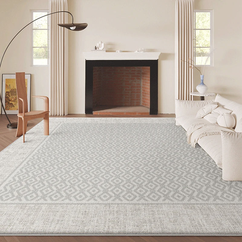 Living room with a patterned rug, sofa, and fireplace.