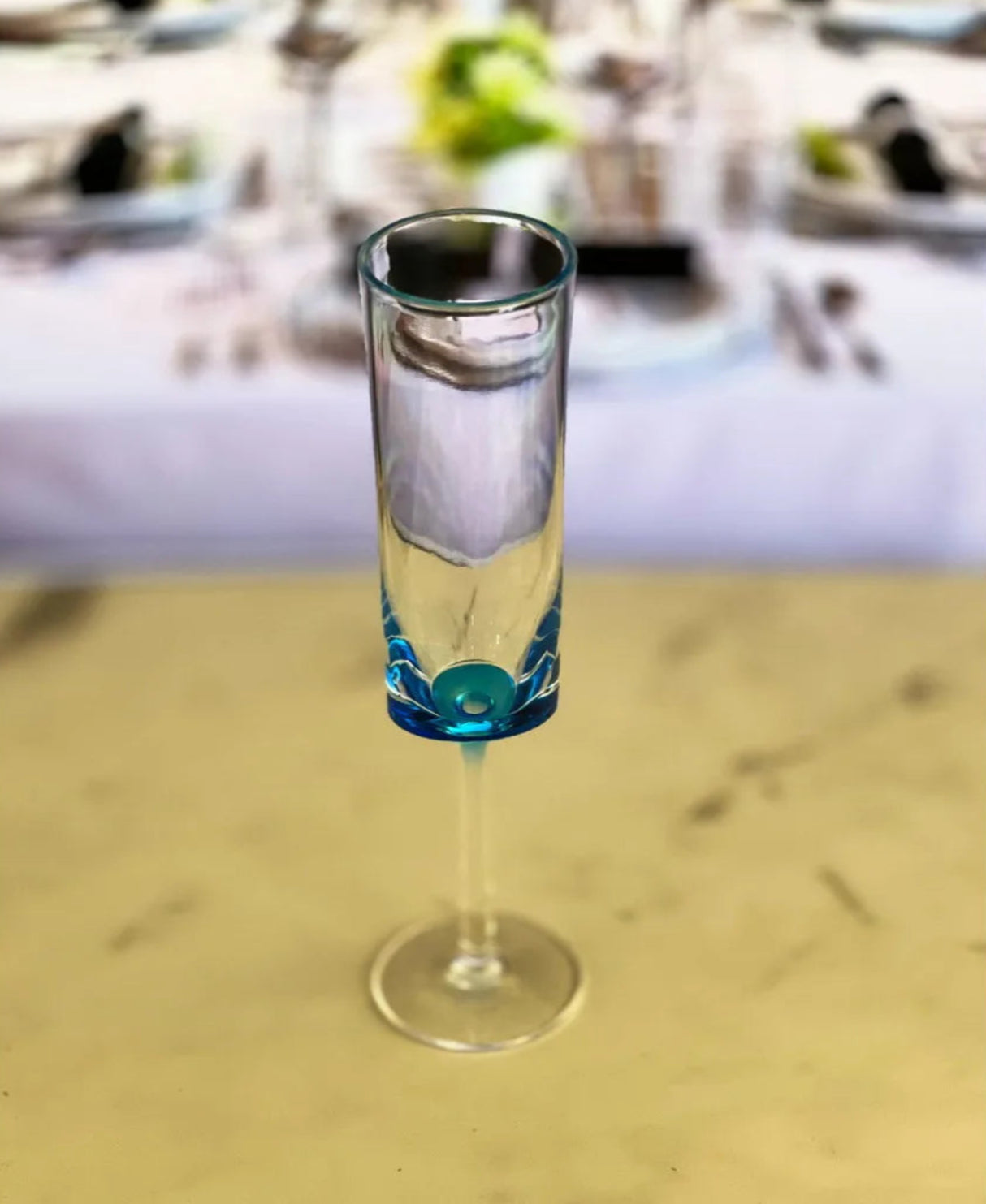 Clear glass with blue decorative element on a blurred background