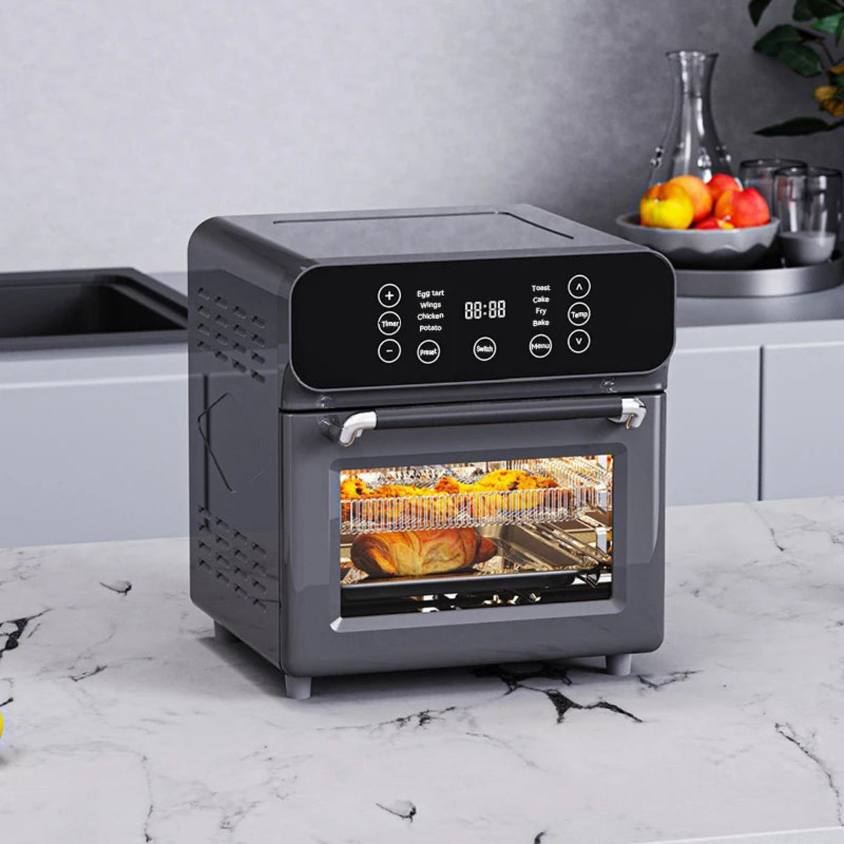 Gray toaster oven on a kitchen counter with food inside