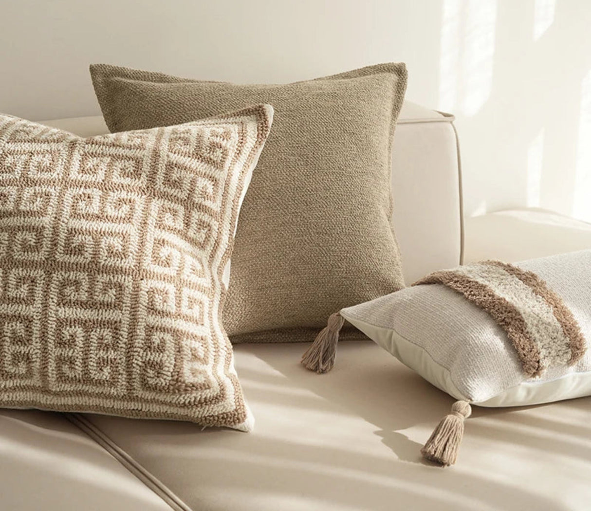 Decorative pillows on a sofa with 'BACKTO HOME' branding.