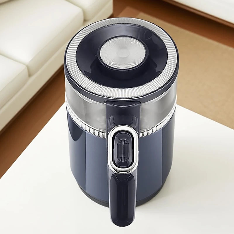 Black and silver handheld vacuum cleaner on a white surface with a blurred background