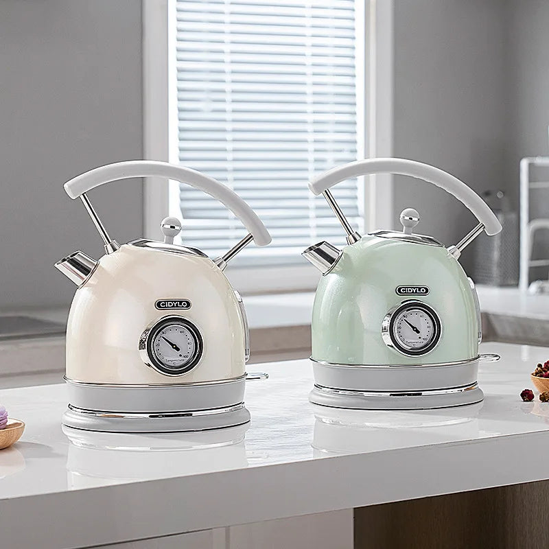 Two electric kettles, one cream and one mint green, on a kitchen counter.