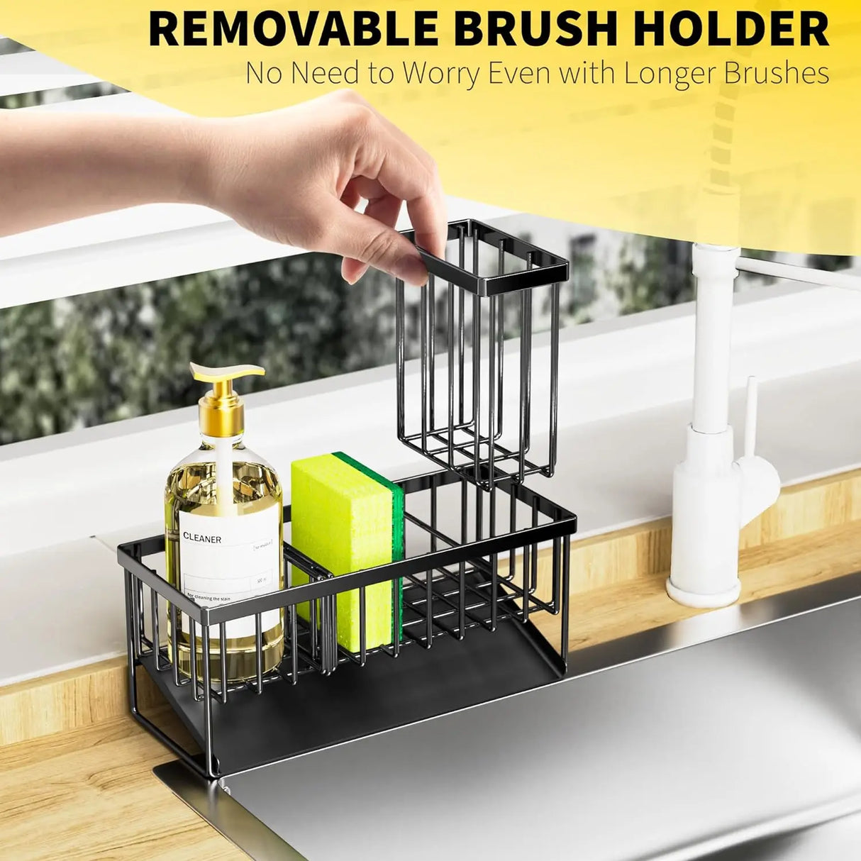 Black removable brush holder on a kitchen sink with cleaning supplies.