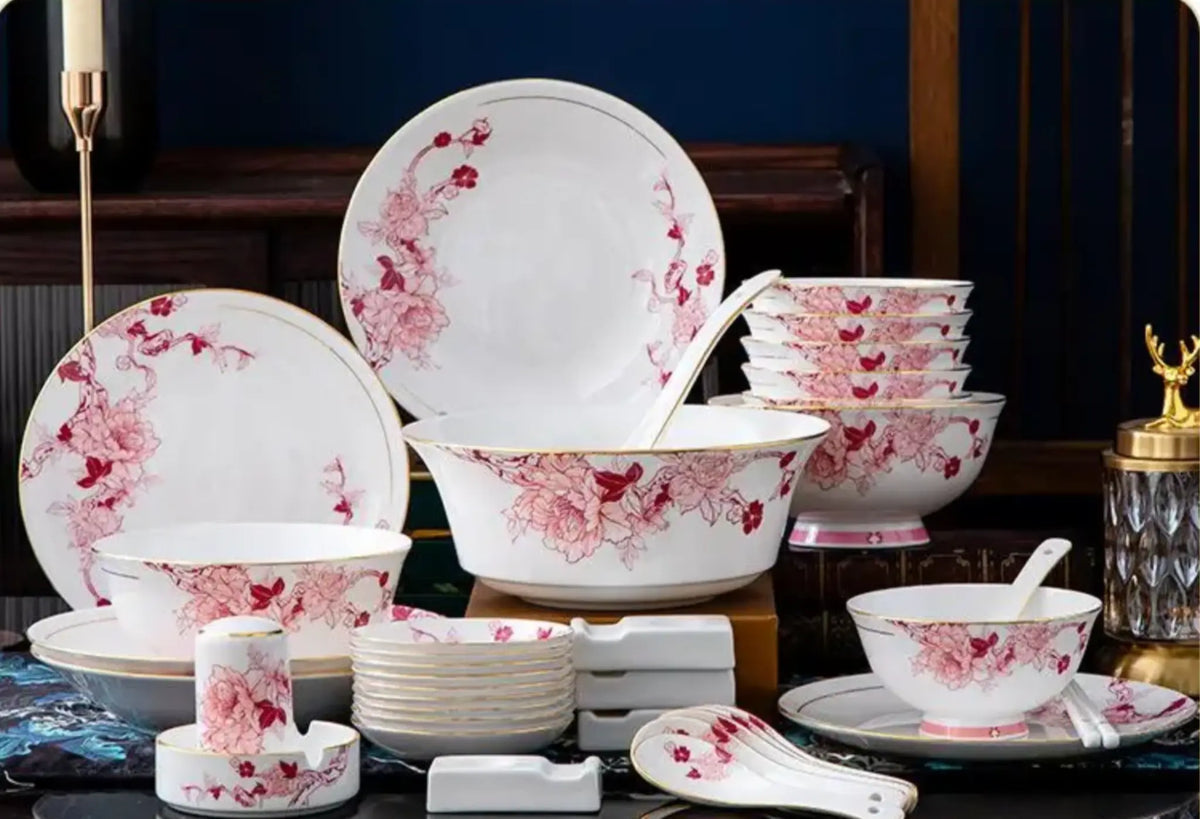 Set of ceramic dishes with floral design on a dark background