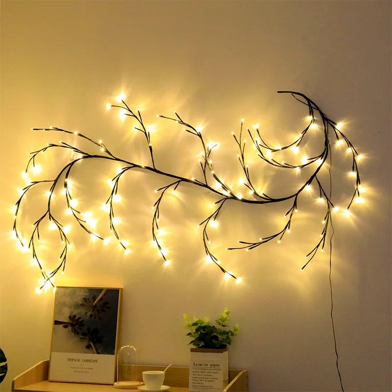 Decorative string lights shaped like branches on a wall with a shelf below.
