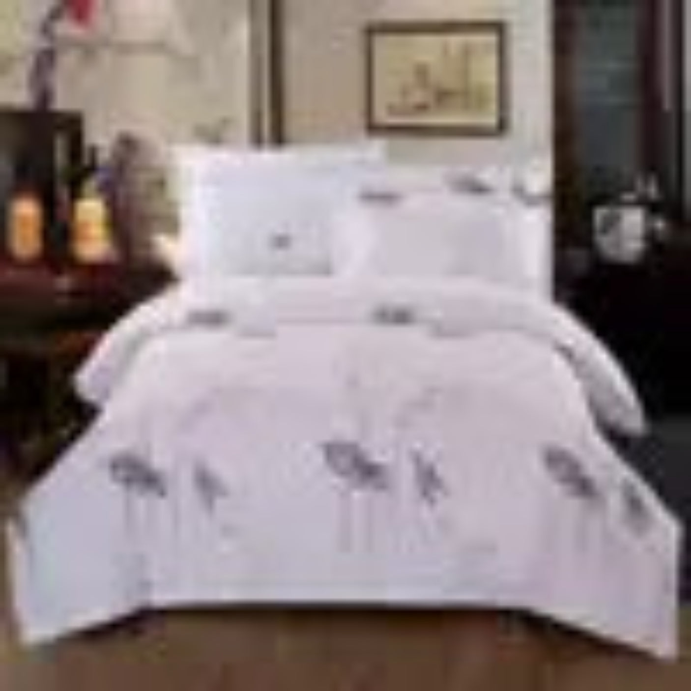 White bedspread with floral patterns on a bed
