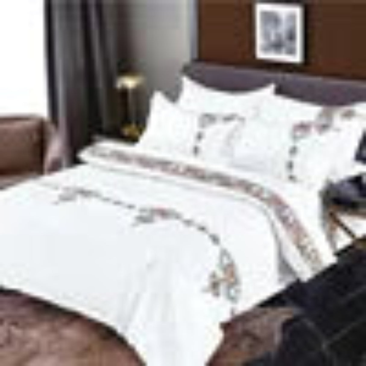 White bedding set with decorative patterns on a bed