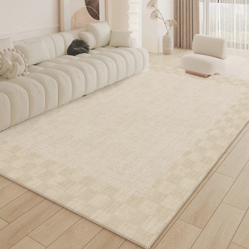 Beige rug in a living room with a white sofa and wooden floor.