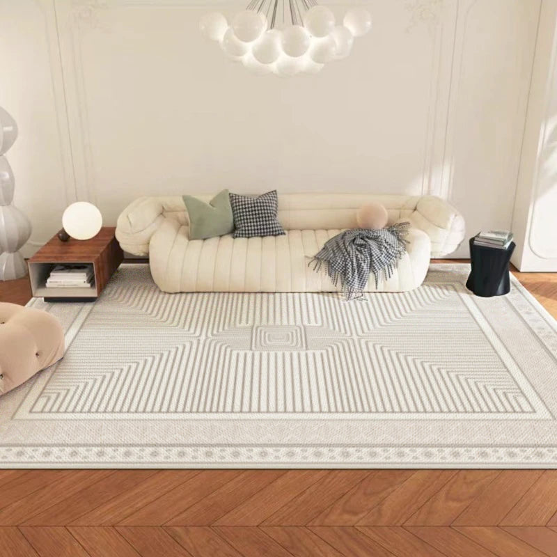 Living room with a beige sofa, patterned rug, and decorative pillows.