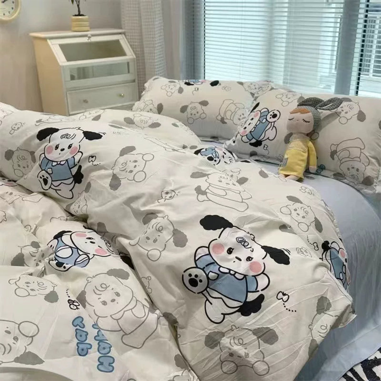 Bedding set with cartoon cow design in a bedroom setting