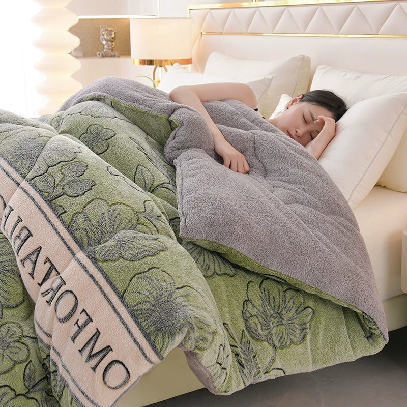 Person lying on a bed under a floral-patterned comforter with 'OMNIA' branding.