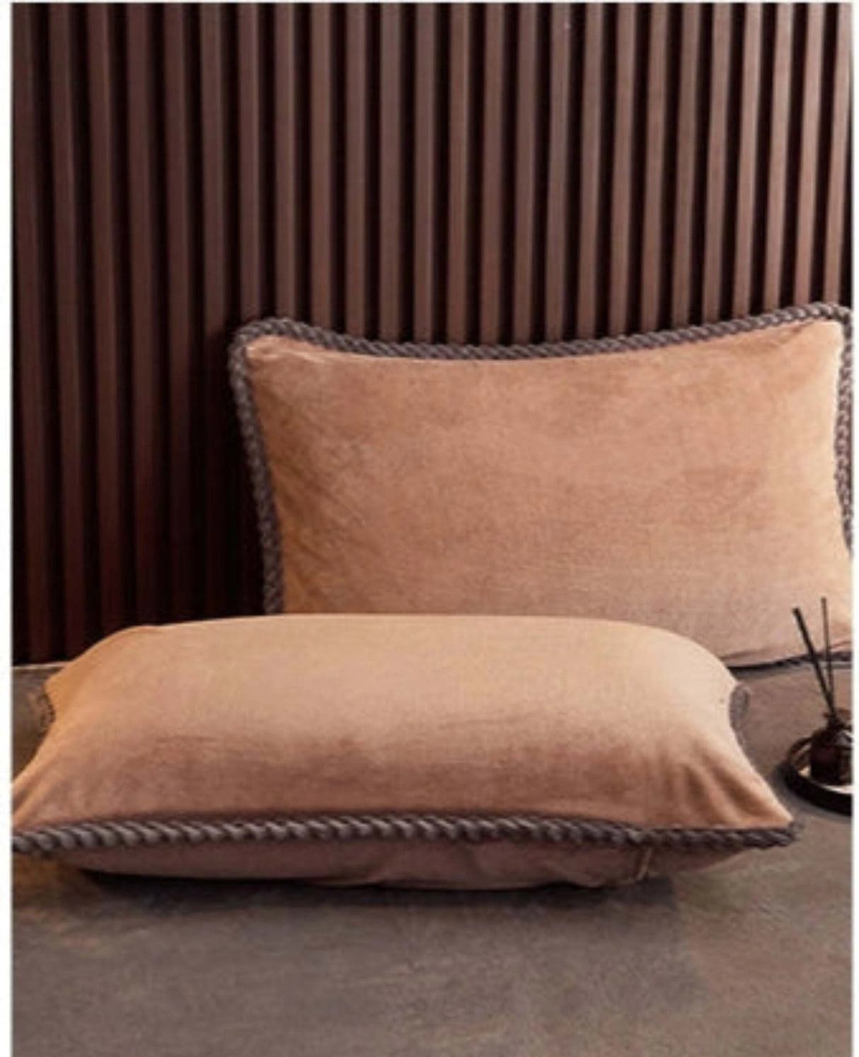 Two brown pillows on a bed with text and icons on a white background