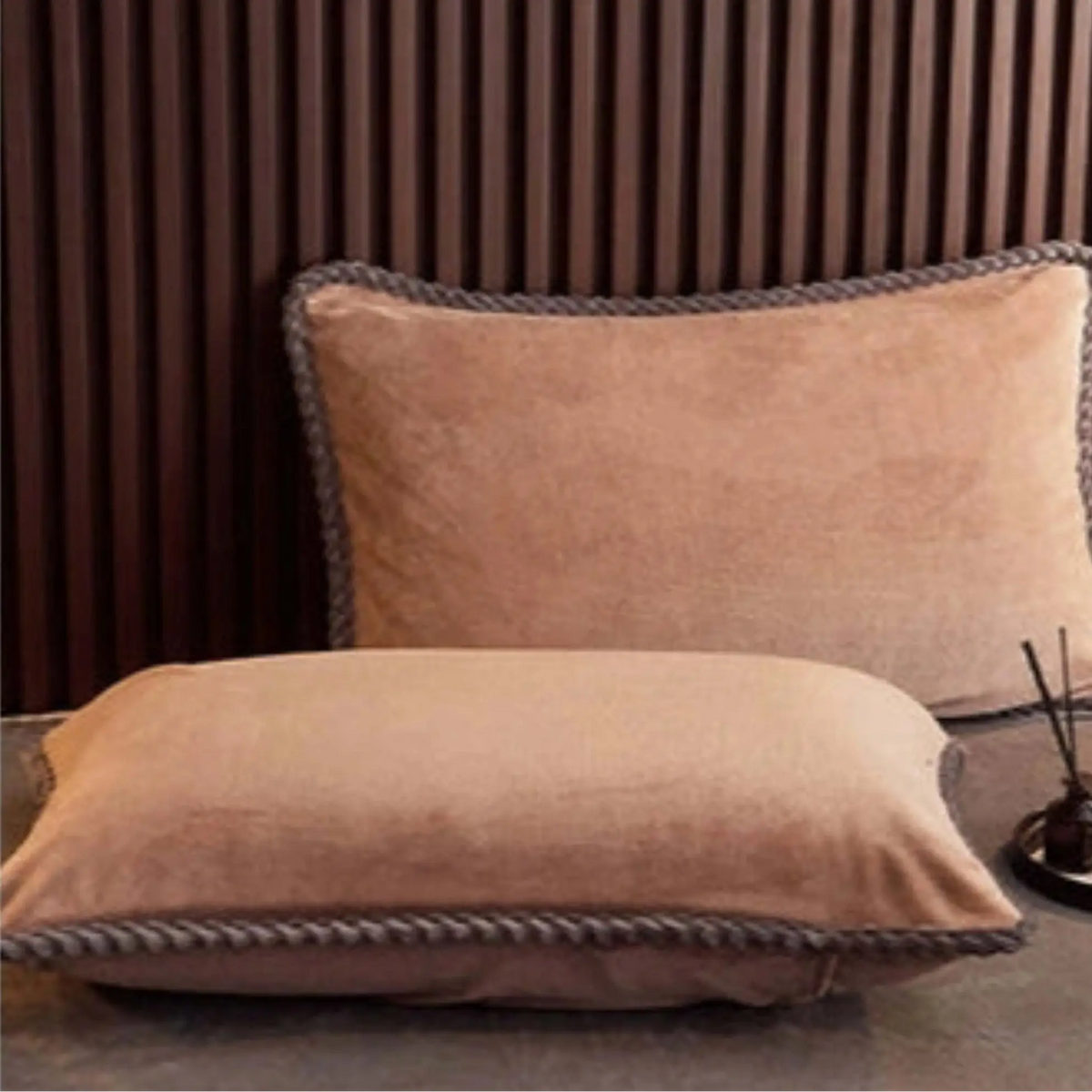 Two brown pillows on a bed with text and icons on a white background