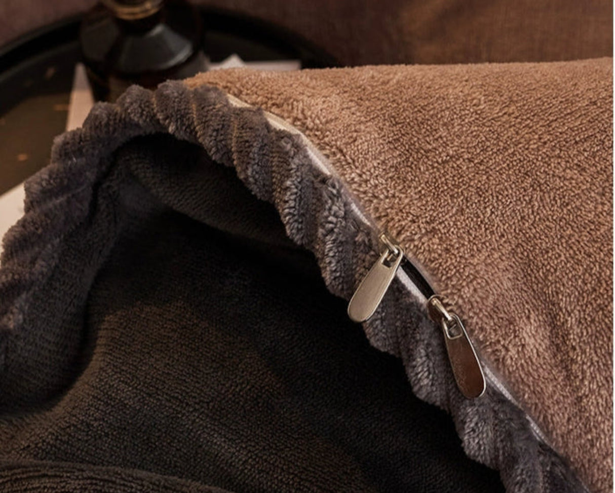Close-up of a brown and gray fleece blanket with a zipper.