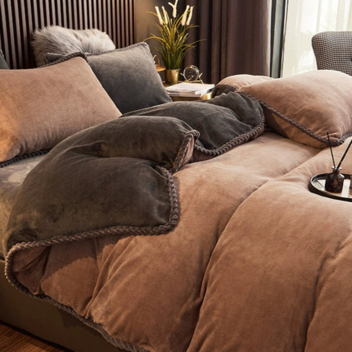 Brown bedding set on a bed in a bedroom with decorative elements.