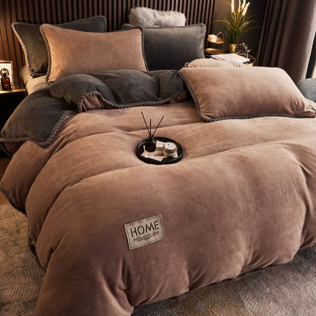 Brown textured comforter with 'HOME' label on a bed in a cozy room.