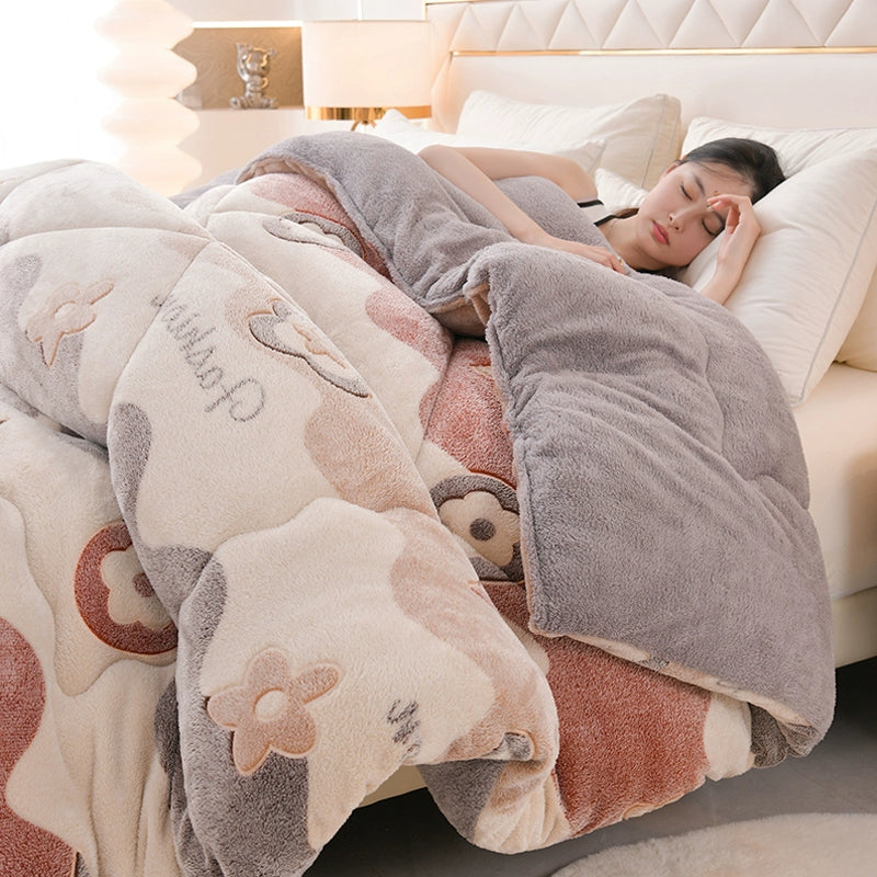 Person lying on a bed under a floral-patterned blanket with cartoon characters.