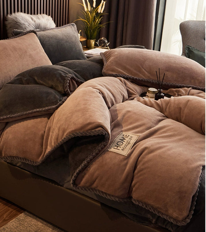 Brown comforter on a bed with decorative elements in a bedroom setting