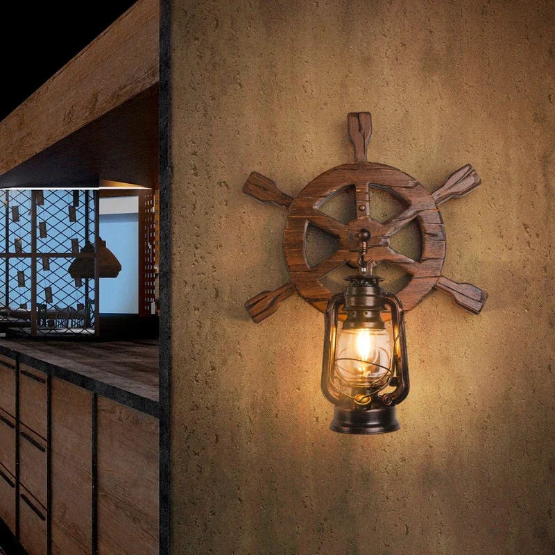 Wooden ship's wheel wall light fixture on a textured wall.