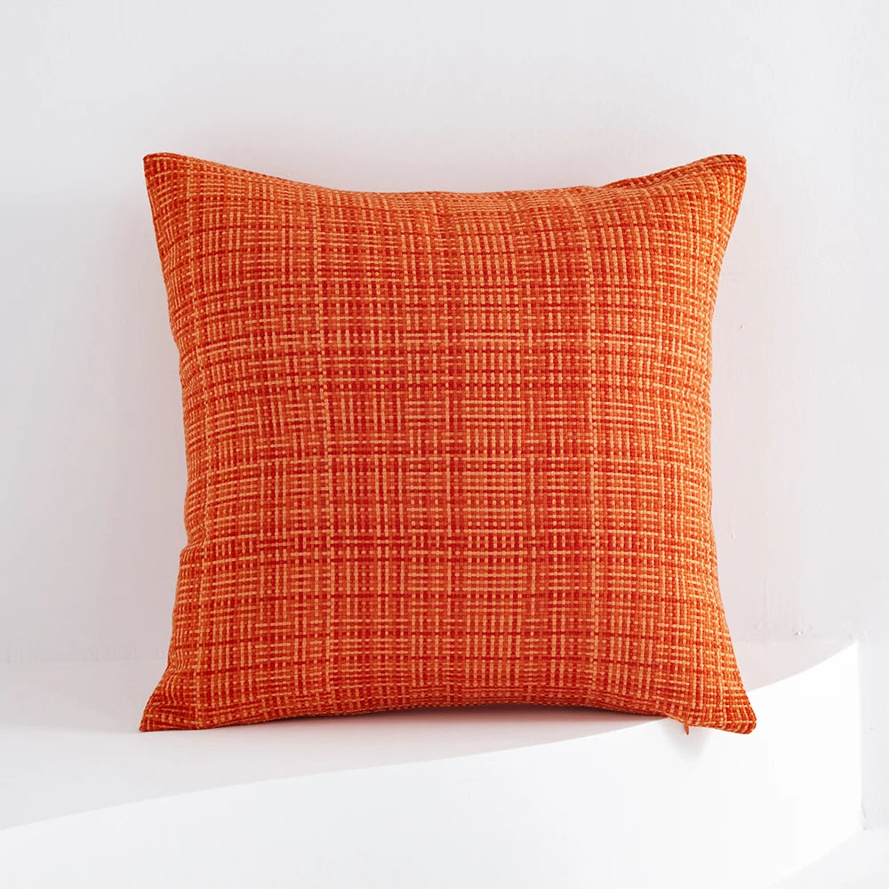 Orange textured pillow on a white background