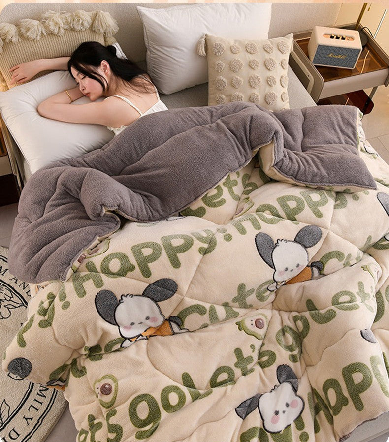 Person lying on a bed with a cartoon-themed comforter and gray blanket