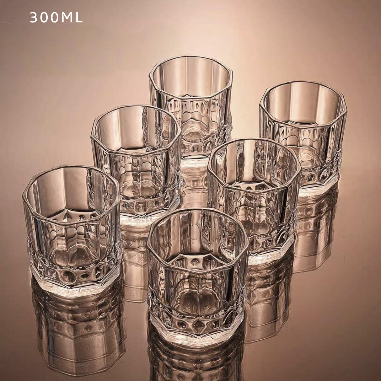 Set of six clear glass tumblers with textured design on a reflective surface.