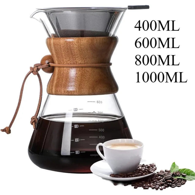 Wooden coffee maker with glass carafe, cup of coffee, and coffee beans on a white background