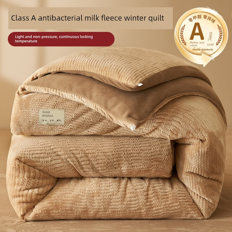 Beige winter quilt with text about antibacterial milk fleece on a beige background