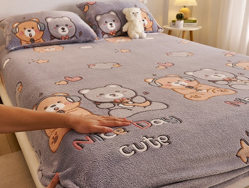 Fluffy teddy bear-themed blanket on a bed with a hand touching it, featuring text about its properties.