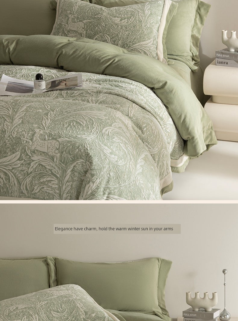 Green patterned bedding set on a bed with decorative pillows and a nightstand.