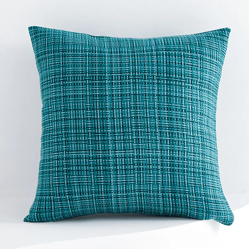 Teal textured pillow on a white background
