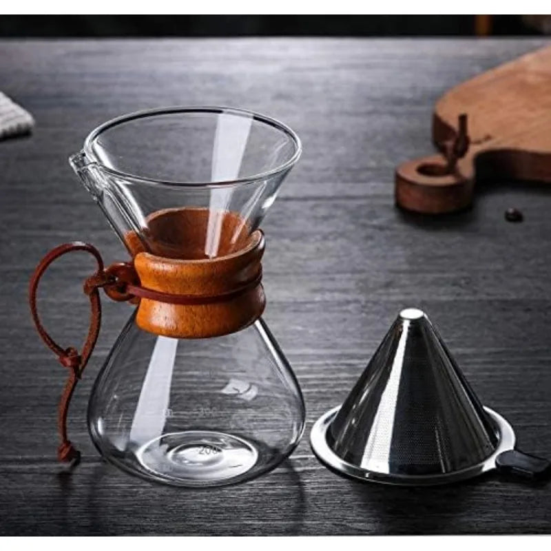 Glass coffee maker with wooden collar and metal filter on a dark surface