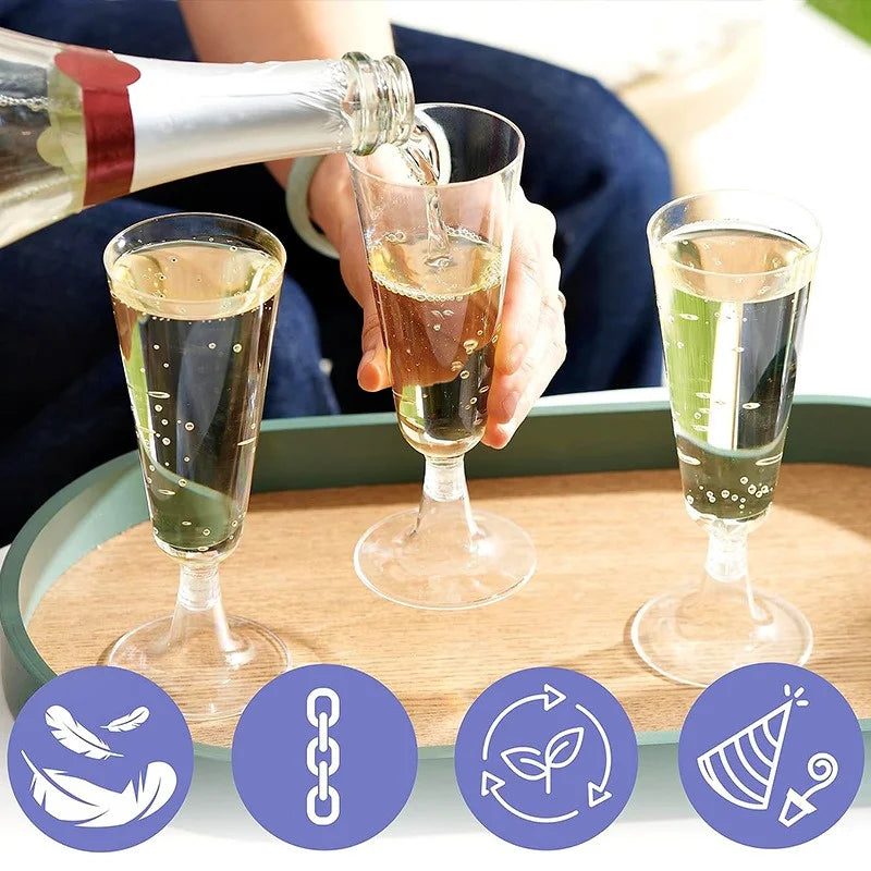 Person pouring champagne into three glasses on a wooden tray.