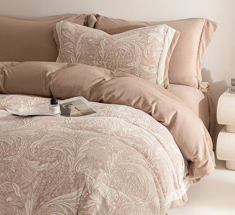 Neatly made bed with patterned bedding and pillows in a bedroom setting.