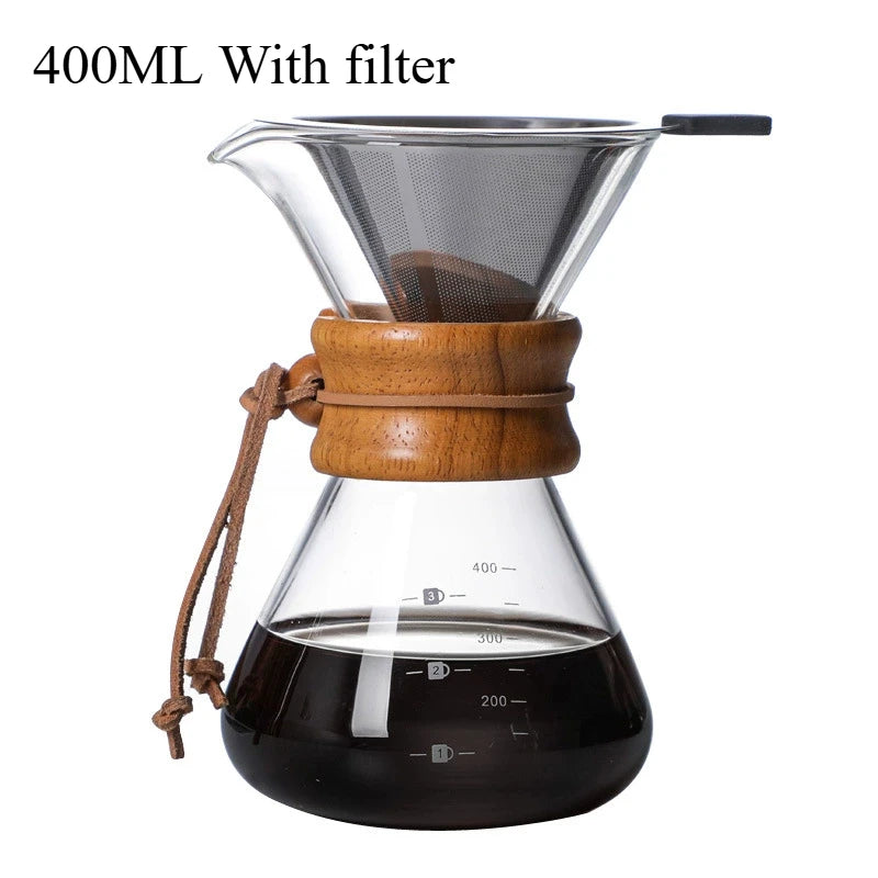 Clear glass coffee maker with wooden collar and filter on a white background
