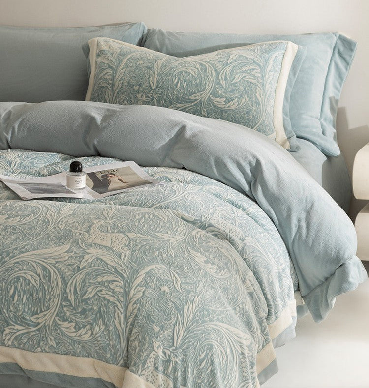 Bedding set with floral pattern in a neutral color scheme on a bed.