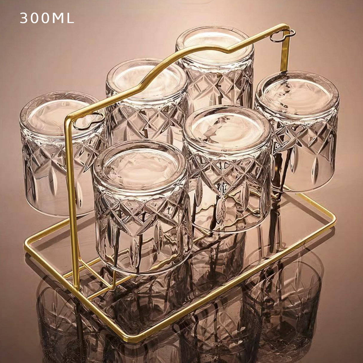 Set of six clear glass jars with a gold metal stand on a reflective surface.