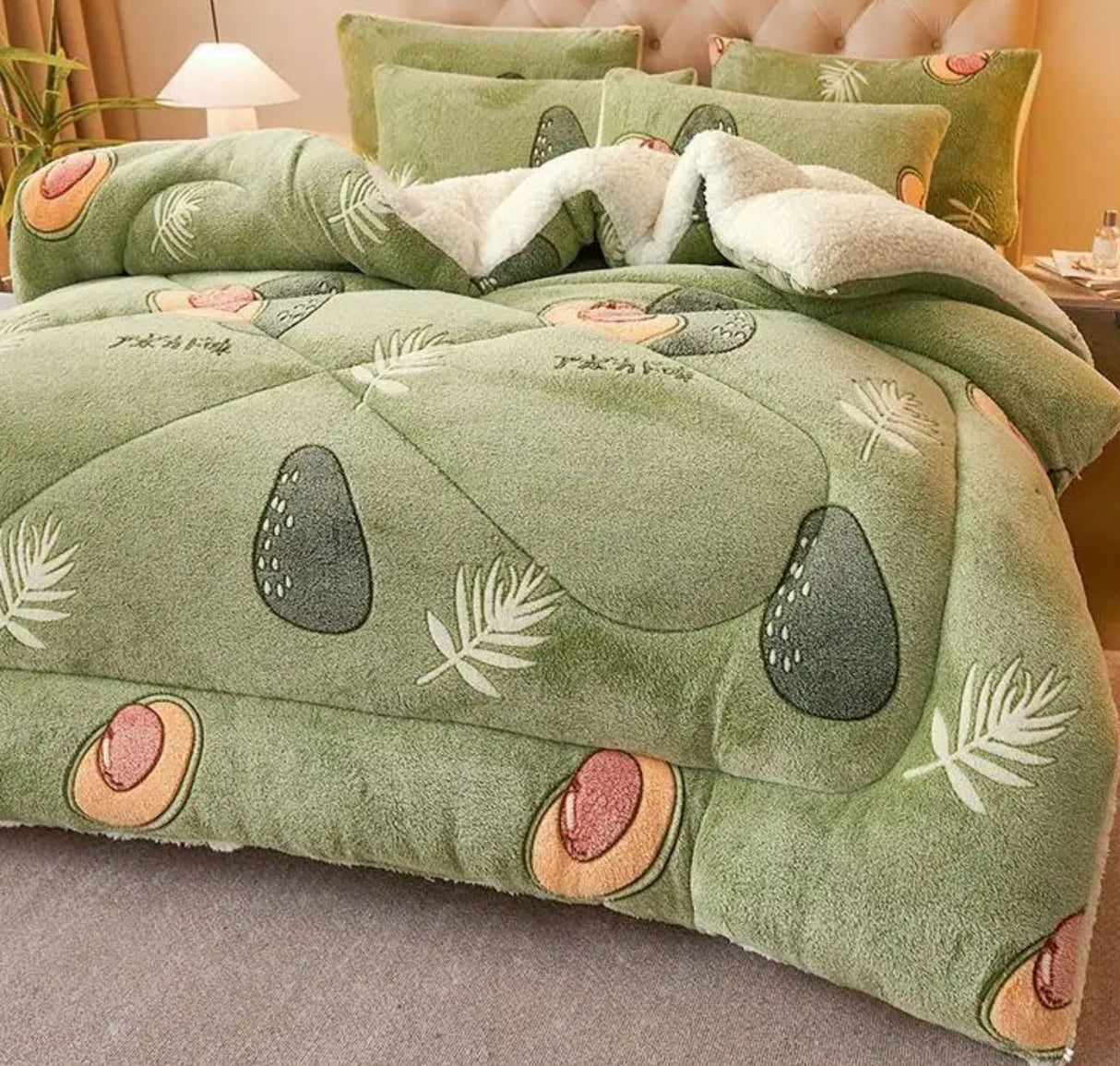 Green textured blanket with leaf patterns on a bed, featuring text about the product.