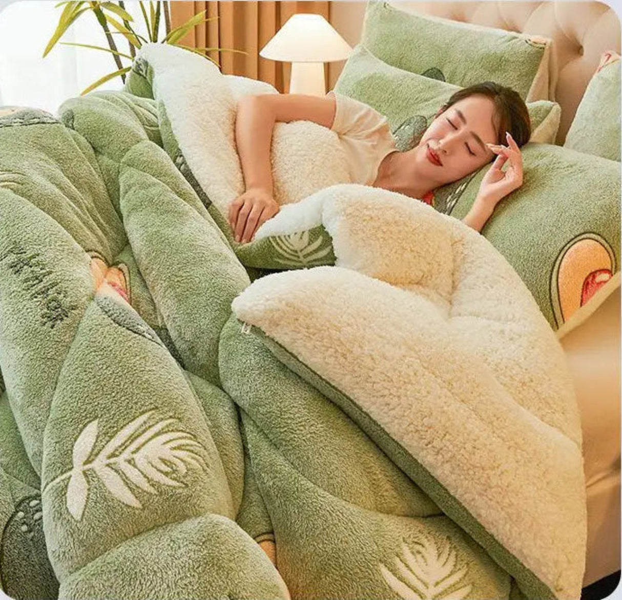Woman lying on a bed with green and beige floral-patterned bedding