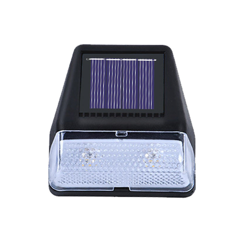 Solar-powered outdoor light with visible solar panel on a white background