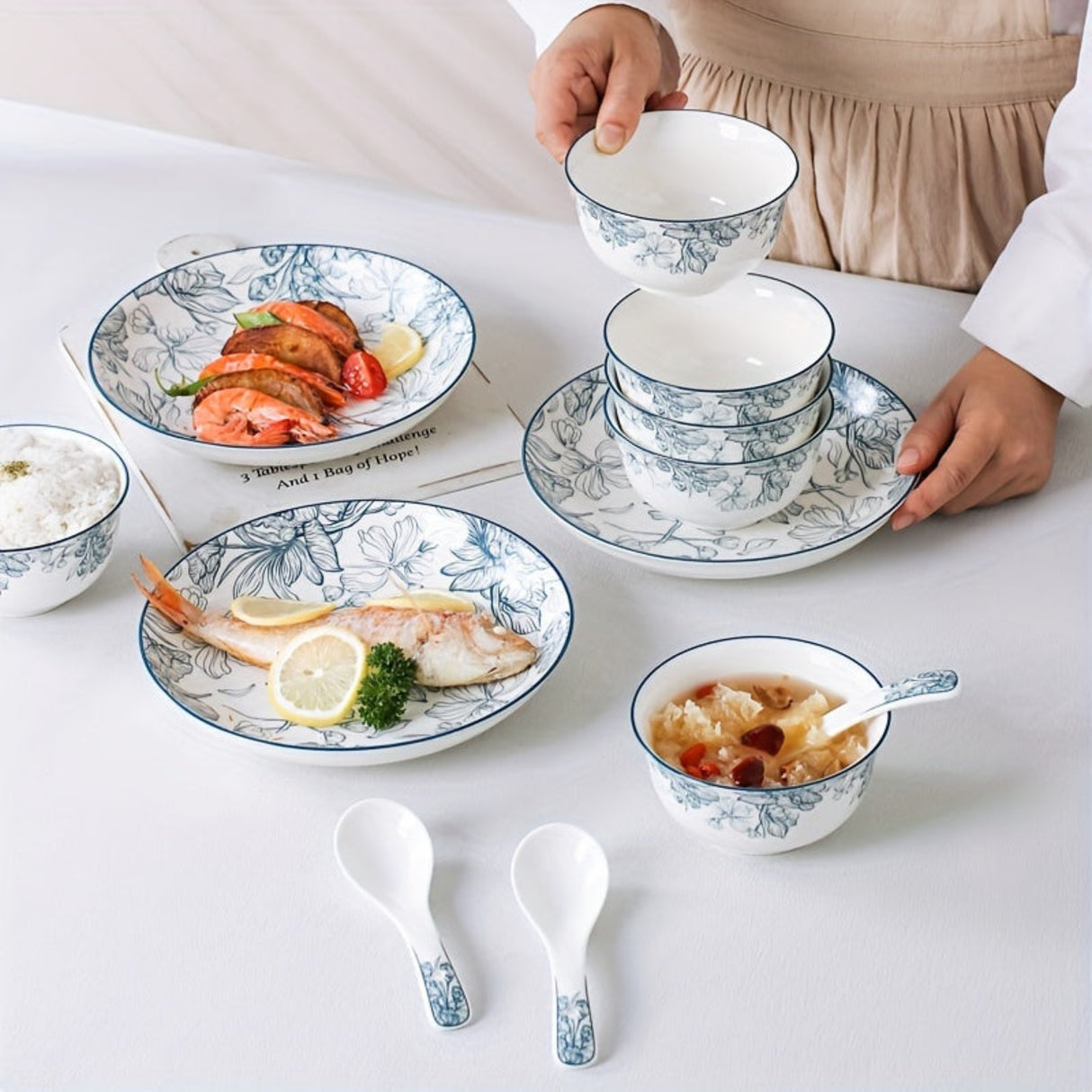 Set of ceramic dishes with floral patterns on a white table.