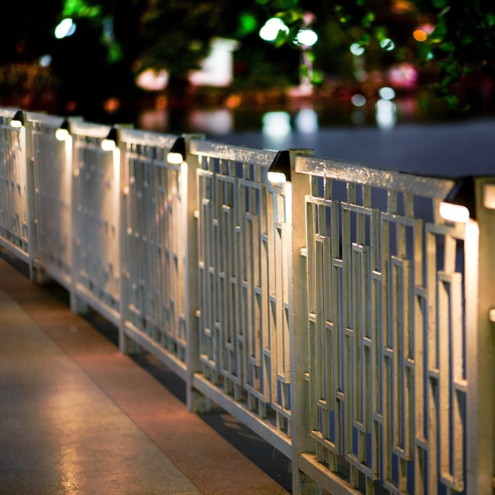 Decorative metal railing with lights on a blurred night scene background