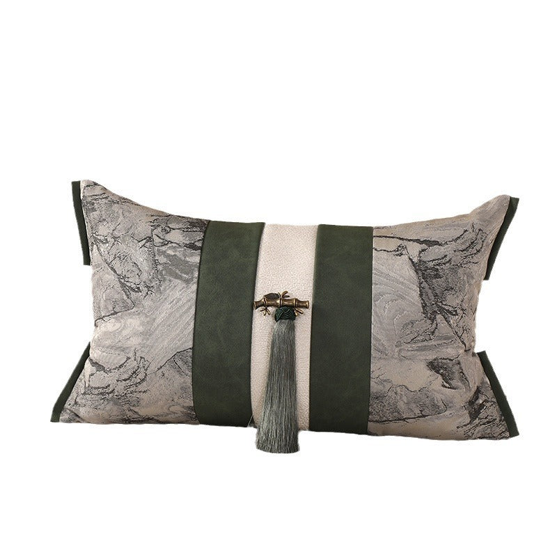 Decorative pillow with geometric pattern and tassel on a white background