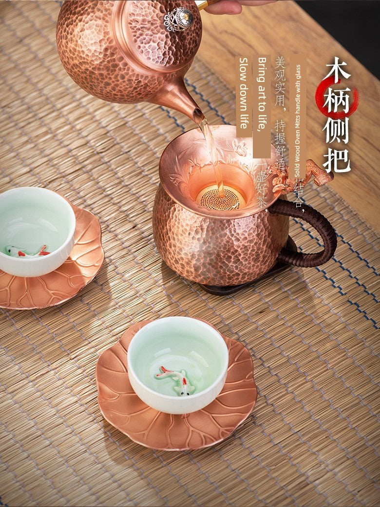 Copper teapot and cups on a wooden surface with text overlay